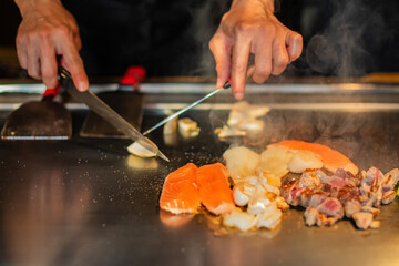 Chef cooking in Japanese teppanyaki restaurant