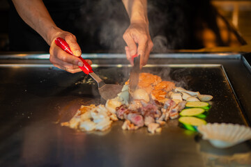 Chef cooking in Japanese teppanyaki restaurant