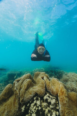 woman using a stinger suit in the great barrier reef in summer time .