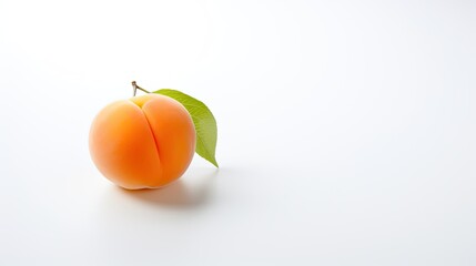 A fresh apricot placed on a white background, showcasing its natural color and texture.