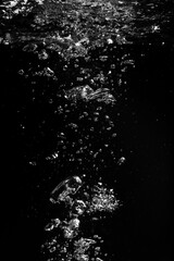 Air bubbles in water on black background