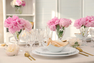 Fototapeta na wymiar Stylish table setting with beautiful peonies and fabric napkin indoors