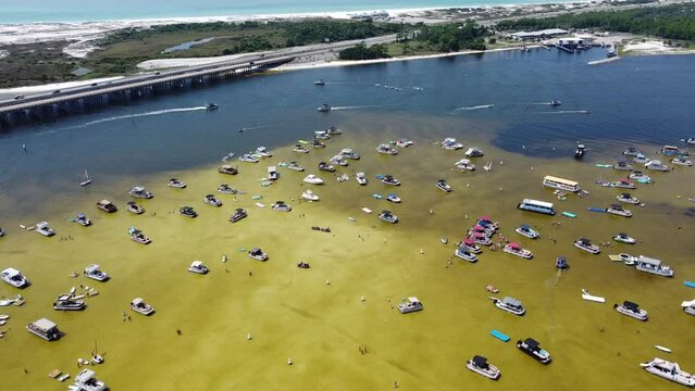Crab Island shallow low tide brackish water near Okaloosa Island Grass Flats and Destin Bridge, Florida, busy boating, pontoons, jet skis, paddleboards, swimming, wading