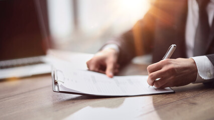 Businessman signs contract agreement paper or business legal form with trust and professionalism.