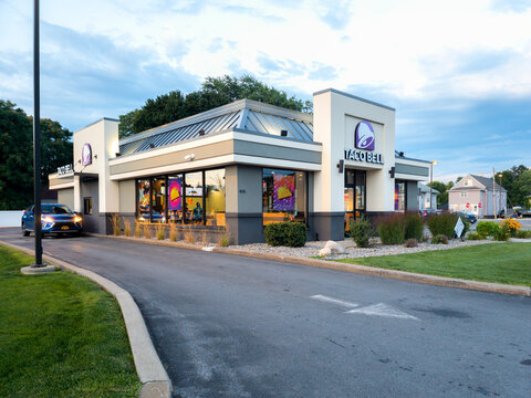 Yorkville, New York - Aug 17, 2023: Evening View of Taco Bell Drive-thru Restaurant Building. Taco Bell, a fast-food restaurant offering a Mexican-inspired menu, serves more than 5,800 locations.