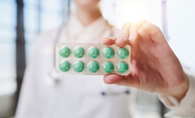 Close up portrait female doctor scientist pharmacist looking at camera presenting new effective pill medicine.