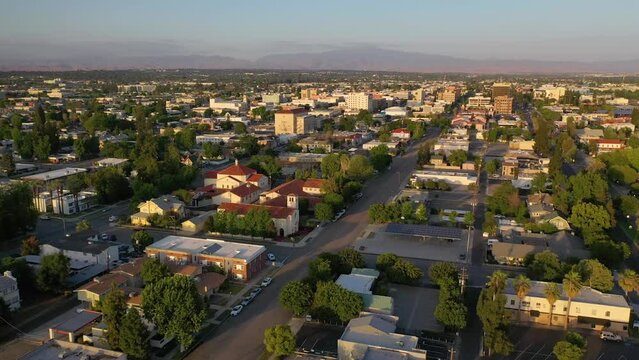 2023 - Excellent aerial footage moving over a neighborhood in Bakersfield, California at dusk.