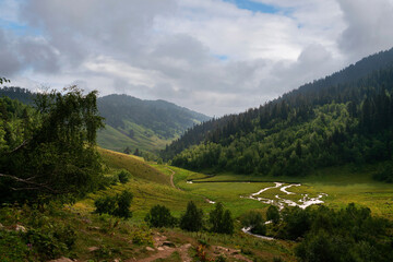 The valley of the Malaya Dukka River surrounded by the mountains of the North Caucasus and the tourist trail to the Dukka Lakes on a sunny summer day, Arkhyz, Karachay-Cherkessia, Russia © Ula Ulachka