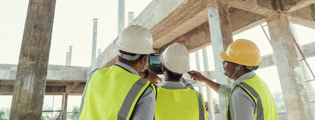 Civil Engineer and Contractor working in construction site. Team Architect working use BIM...