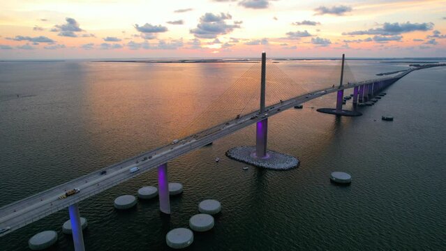 Sunshine Skyway Bridge spanning the Lower Tampa Bay and connecting Terra Ceia to St. Petersburg, Florida, USA. Day video. Ocean or Gulf of Mexico seascape. Reinforced concrete bridge structure.