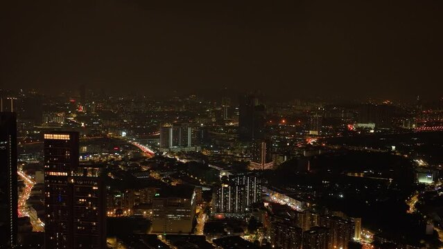 Kuala Lumpur, Malaysia - September 11, 2022: Aerial view of night illumination in Kuala Lumpur city with skyscrapers.