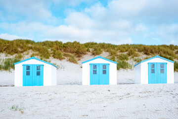 Fototapeta na wymiar white blue beach house on the beach Texel Netherlands, a beach hut on the Dutch Island of Texel