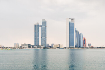 Fototapeta na wymiar View from territory of Heritable village Abu Dhabi museum to buildings located on opposite side of bay in Abu Dhabi city, United Arab Emirates