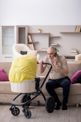 Old man looking after newborn at home