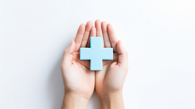 Top view of hands holding blue plus symbol on white background, healthcare medical concept.