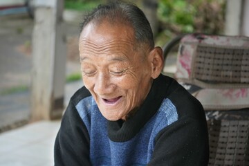 old man laughing wearing black panther