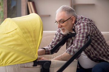 Old man looking after newborn at home