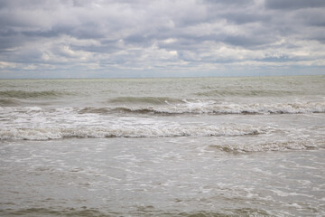 Waves on the beach of the Baltic Sea in cloudy weather