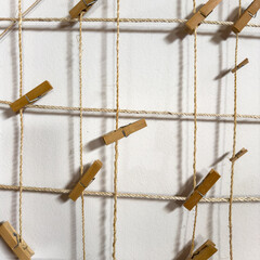 Wooden pegs clipped to string with nothing attached on home made photo wall