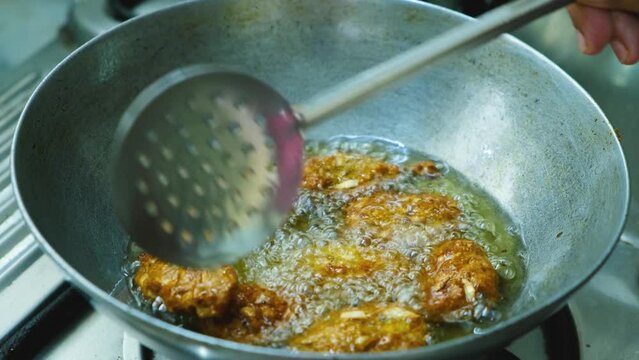 frying Raw Koftas, pakoda in kadai for the vegetable  Kofta curry an Indian Food, 4k, Close up shot 