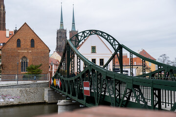 Tumski bridge and Wroclaw Cathedral. Wroclaw historic center cityscape. City hall architecture buildings. Old town landmark cathedrals church. Travel tourist destination  - obrazy, fototapety, plakaty