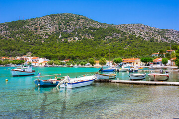 Fototapeta na wymiar Small fishing village of Posidonio with turquoise blue Aegean sea on Samos island, Greece