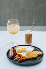 Portrait or vertical shot of Full English Fry Up Breakfast and two drinks which are Tropical...