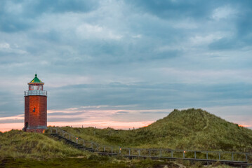 Fototapeta na wymiar Sunset landscape with a lighthouse on Sylt island, Germany
