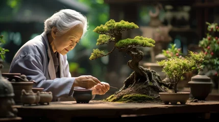 Fotobehang Old asian women trimming bonsai tree, elder people peaceful hobby. Generative AI © Anil Hakim