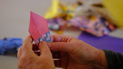 Hand folding Japanese Swan paper origami with colorfull paper pattern.