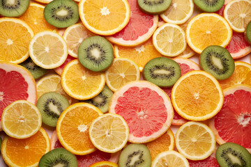 top down background view made of Fresh Sliced organic kiwi, oranges and lemons close-up