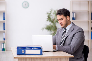 Young male employee working in the office