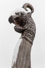 wooden dragon head on Drakkar against a gray sky - 637716367