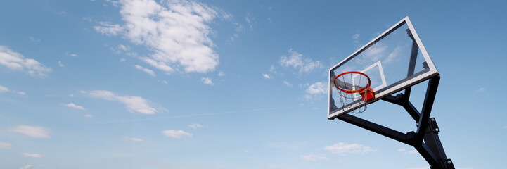 A new basketball hoop against a clear blue sky. The concept of urban sports. Ideal for conveying...