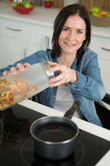 disabled woman cooking meal at home