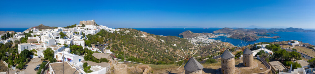 The three windmills of Chora and iconic Monastery of Saint John the Theologian in chora of Patmos island, Dodecanese, Greece