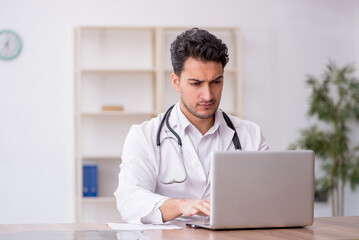 Young male doctor in telemedicine concept