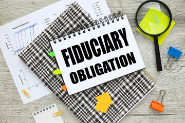 Fiduciary Obligation notepad with spring text on page.pinned stickers