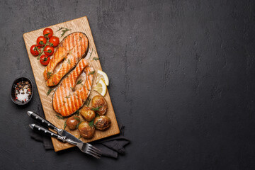 Grilled salmon steaks and potatoes