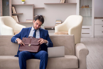 Young male employee working from home during pandemic