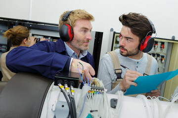 two young engineers working with electronics details