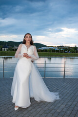 Fototapeta na wymiar Beautiful bride woman in wedding dress on sunset outdoor