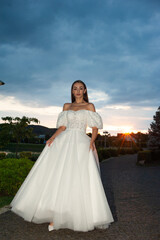Fototapeta na wymiar Beautiful bride woman in wedding dress on sunset outdoor