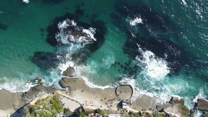 Aerial View of Tide Pools With Sea Foam and Ocean Waves