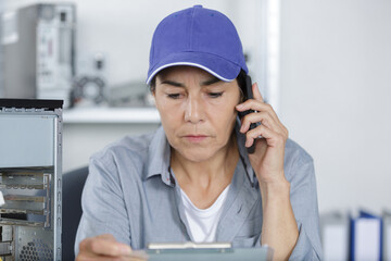 mature female technician on the phone