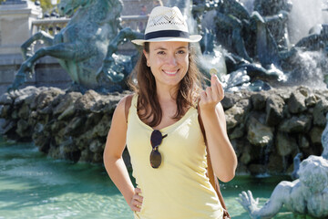woman throws a coin in the fountain