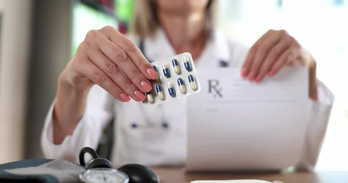 Doctor therapist cardiologist neurologist shows blank prescription paper and blister with pills. Pharmacy and the correct dose of medicines
