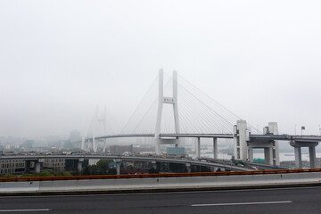 Foggy Nanpu Bridge with Empty Streets and Stunning Sky in Shanghai