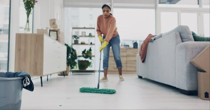 Woman, mopping or cleaning living room floor in house for hygiene, dirt or bacteria safety in housekeeping routine. Person, wipe or equipment for ground dust control, disinfection or germs protection