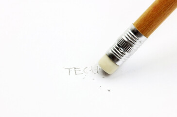 A pencil erasing the word technology written on paper. Concept of analog and therapy against the digital.